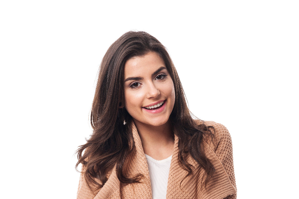 Woman wearing a brown cardigan over a white shirt on a white background